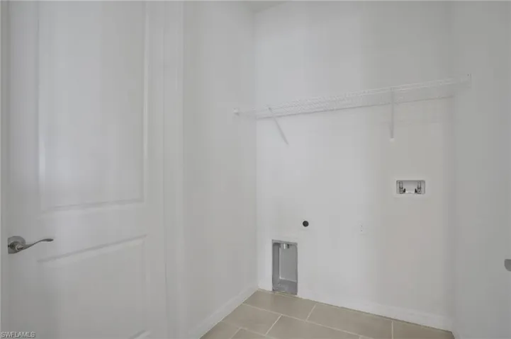 Laundry room with light tile patterned floors, washer hookup, and electric dryer hookup