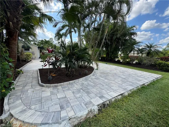 View of community with a patio and a yard