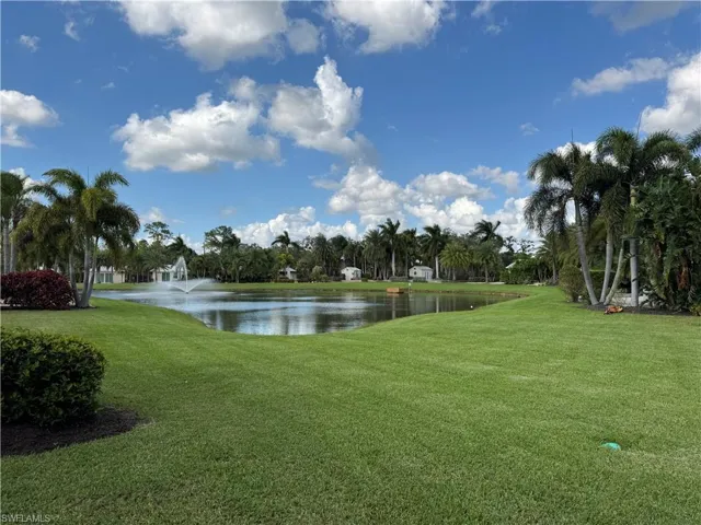 View of home's community with a lawn and a water view