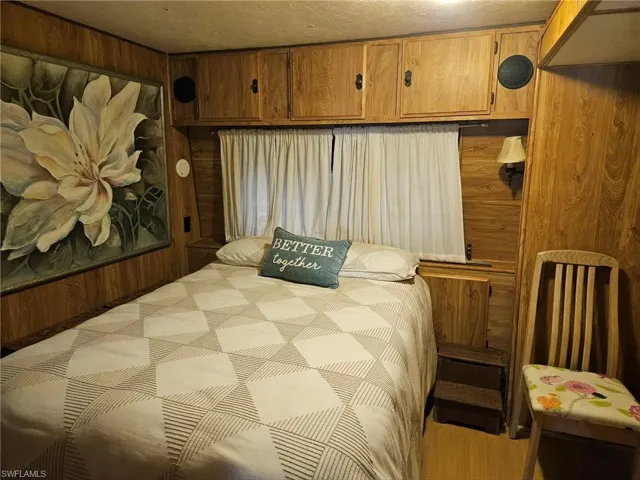 Bedroom featuring wooden walls