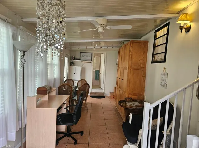 Office area featuring light tile patterned floors and ceiling fan