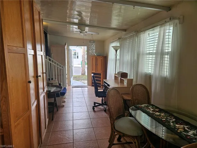 Office area with ceiling fan and tile patterned flooring