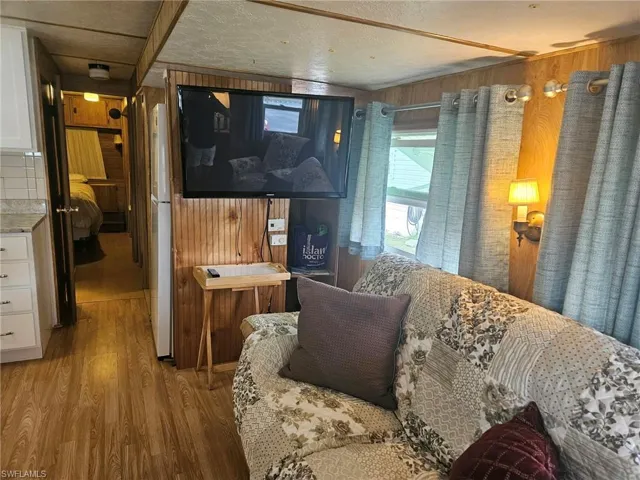 Living area featuring wood walls and wood finished floors