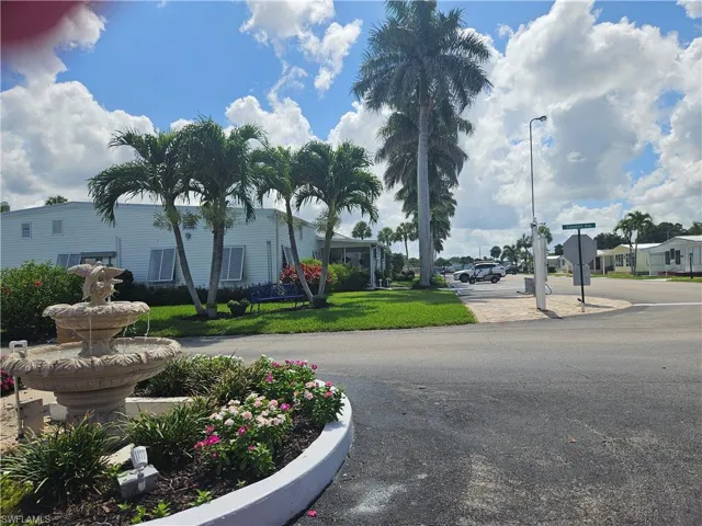 View of asphalt road featuring street lights