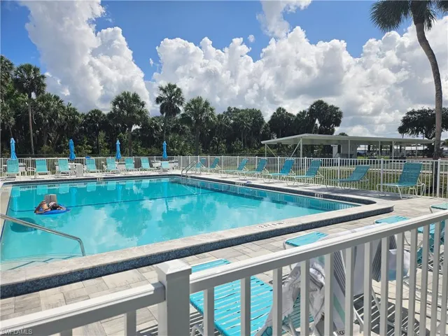 Community pool featuring view of scattered trees