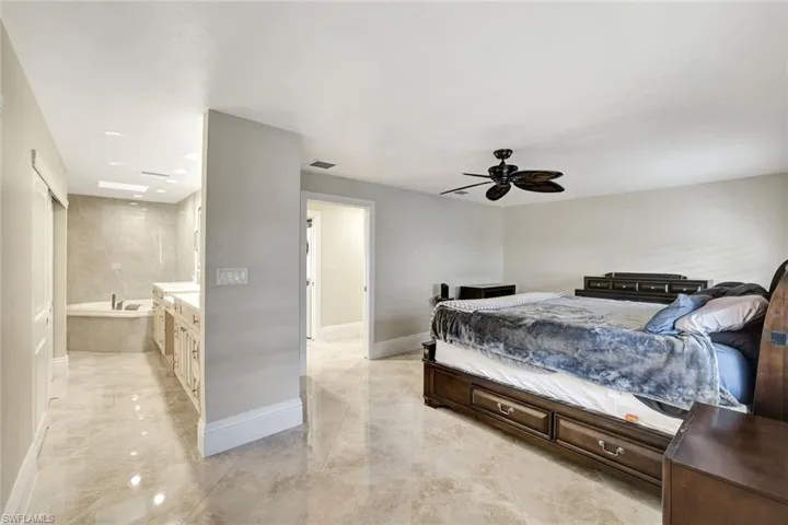 Bedroom with ensuite bathroom and ceiling fan
