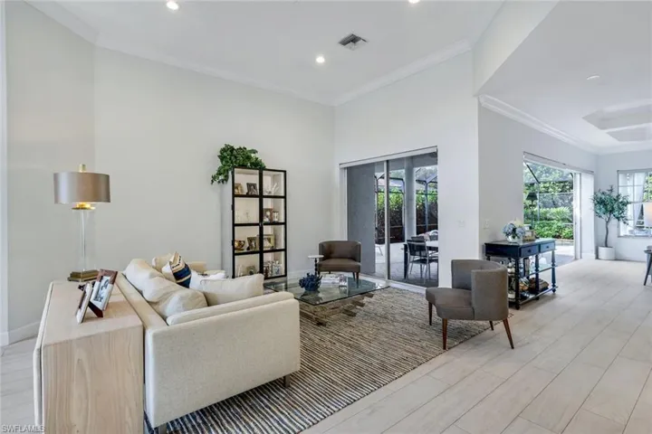 Living room opens onto covered pool deck area