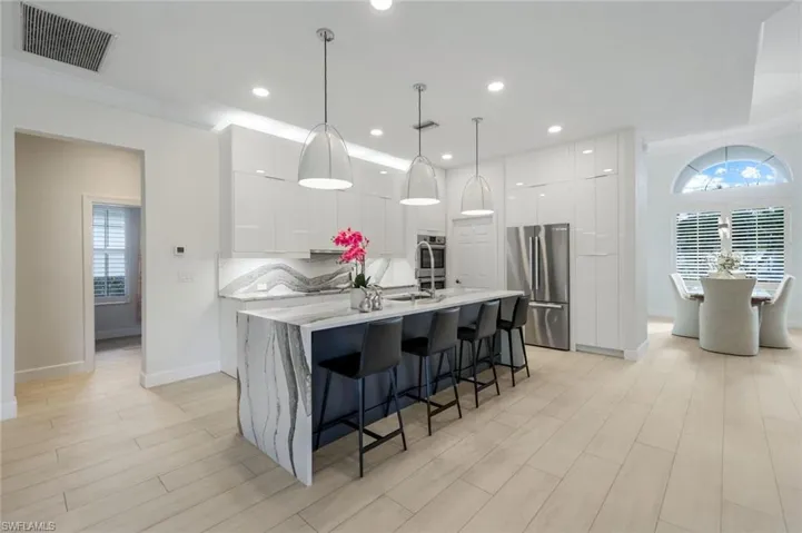 Waterfall countertops in gourmet kitchen