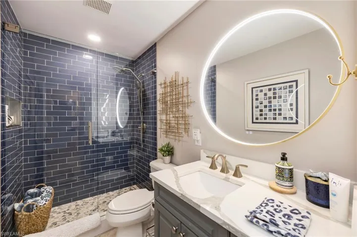 Full bath featuring vanity, a stall shower, and recessed lighting