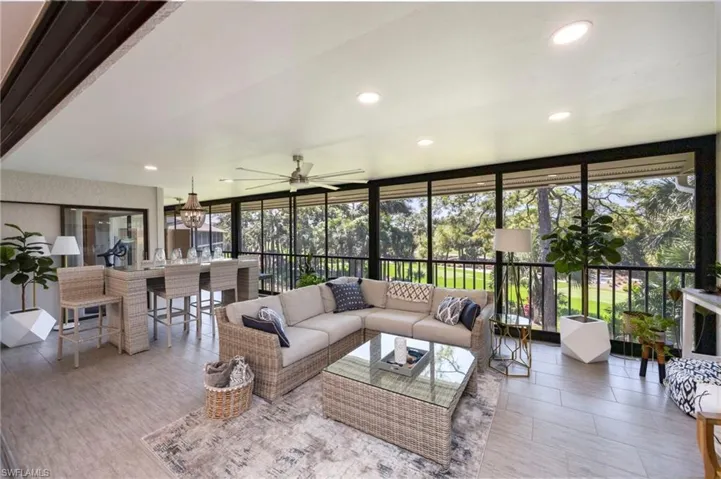 Living room featuring expansive windows, a ceiling fan, and recessed lighting