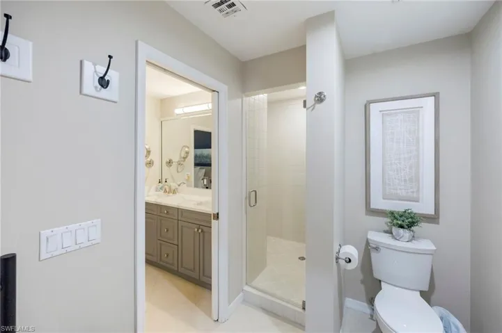 Bathroom with double vanity and a stall shower