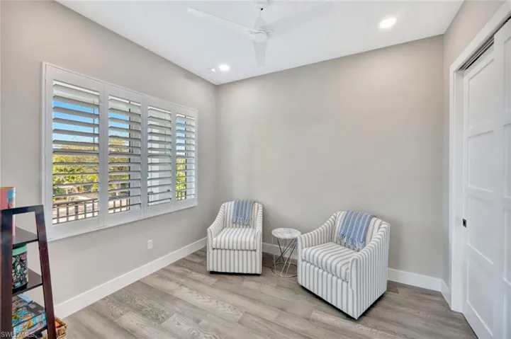 Sitting room with light wood finished floors, recessed lighting, and a ceiling fan