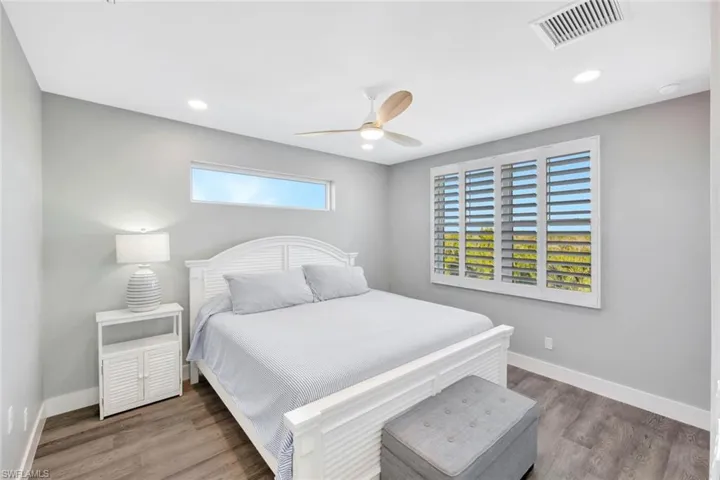 Bedroom featuring wood finished floors, ceiling fan, and recessed lighting