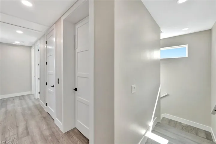 Corridor with recessed lighting and light wood-type flooring