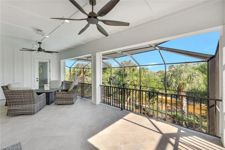 View of patio / terrace featuring a ceiling fan, a sunroom, and glass enclosure