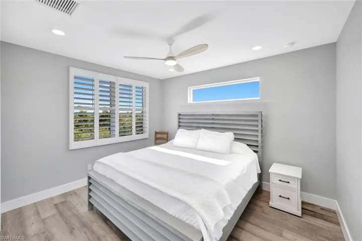Bedroom with light wood finished floors, recessed lighting, and ceiling fan