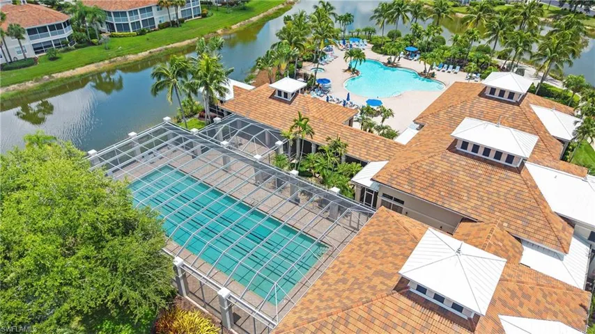 Expansive outdoor aquatic amenities feature a screened lap pool, a lagoon-style pool, and multiple sunning decks