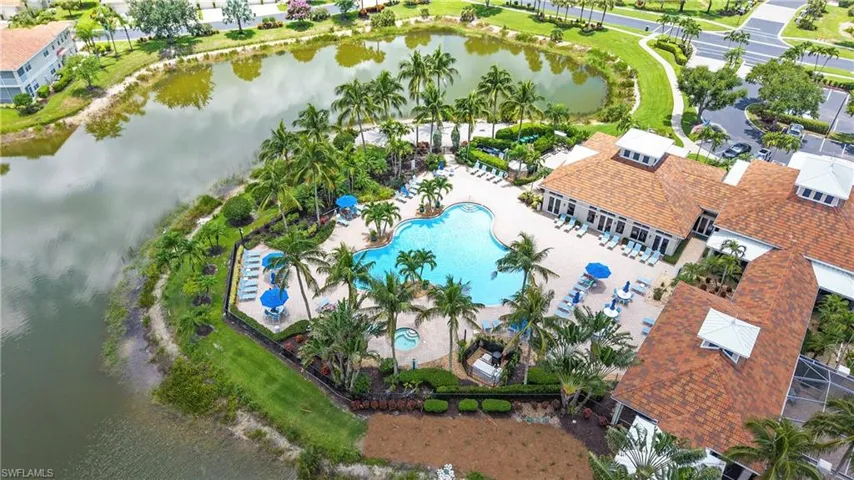 Resort-style pool area featuring a freeform swimming pool, integrated spa, and surrounding lounge seating