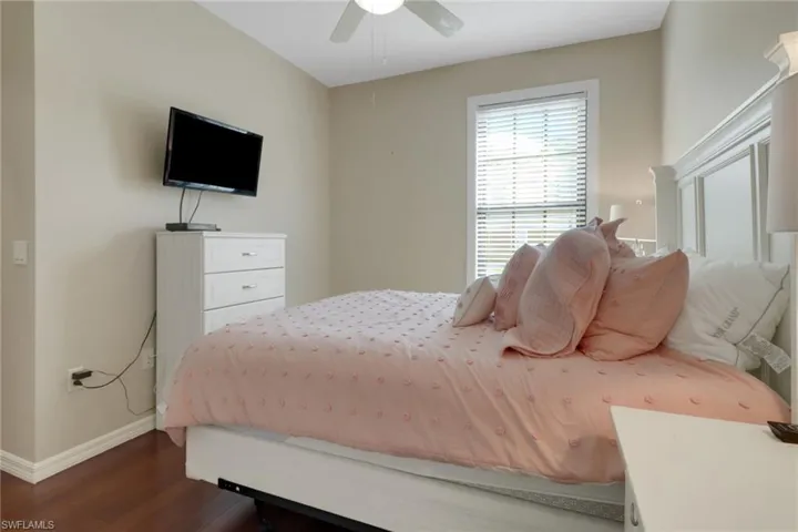 Bedroom featuring dark wood-type flooring and ceiling fan
