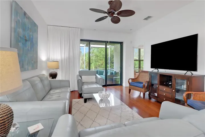 Living room featuring hardwood / wood-style flooring and ceiling fan