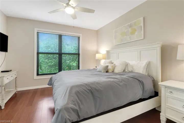 Bedroom featuring dark hardwood / wood-style floors and ceiling fan