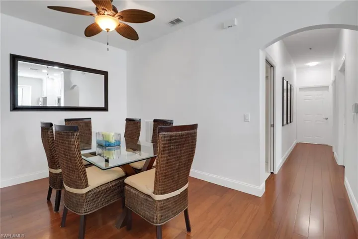 Dining area with hardwood / wood-style floors and ceiling fan