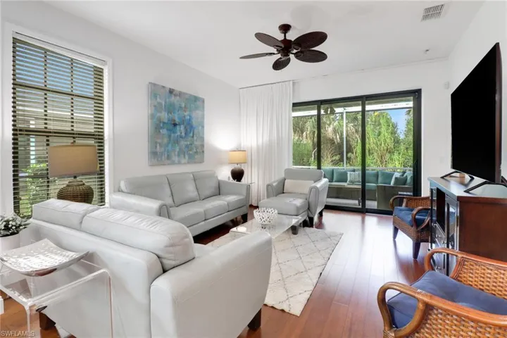 Living room featuring hardwood / wood-style flooring and ceiling fan