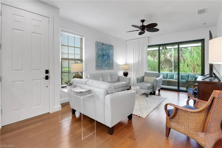 Living room featuring ceiling fan and wood-type flooring