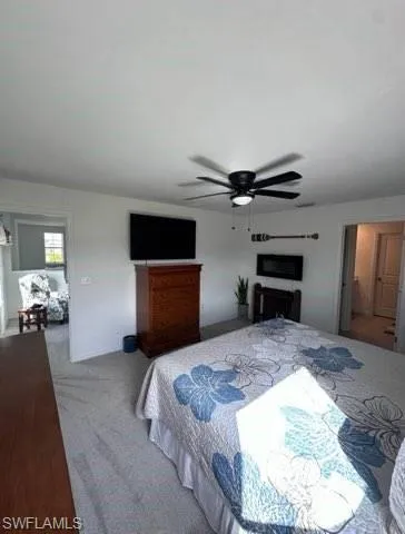 Carpeted bedroom with ceiling fan