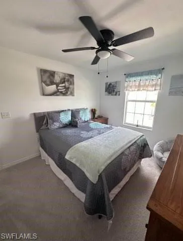 Bedroom with ceiling fan and carpet floors