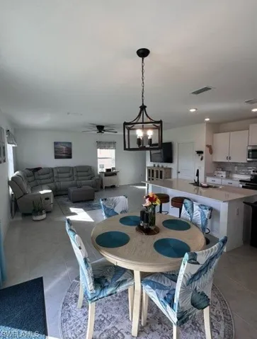 Dining area featuring a ceiling fan and hanging lights