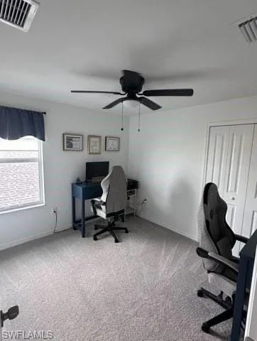 Office featuring light colored carpet and ceiling fan