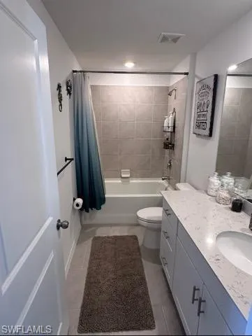 Bathroom featuring vanity and shower / tub combo with curtain