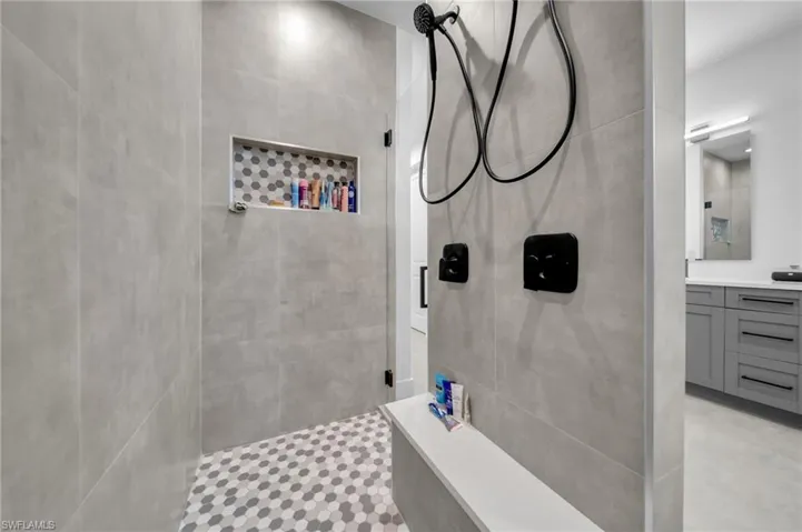 Bathroom with vanity and a tile shower