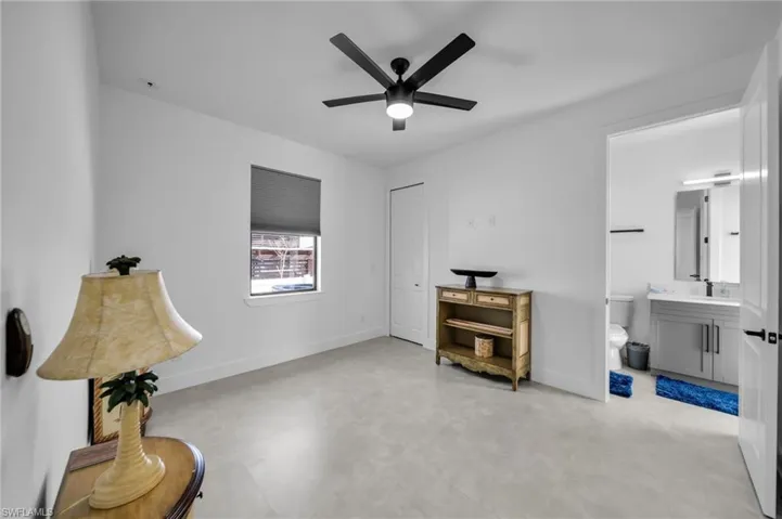 Sitting room featuring baseboards, light floors, and ceiling fan