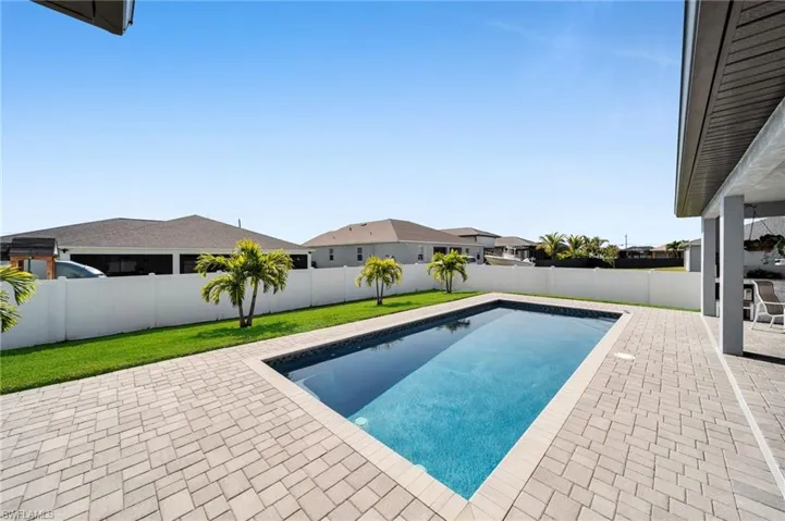 View of swimming pool featuring a fenced in pool, a yard, a patio area, and a fenced backyard