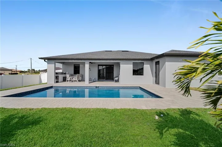 View of swimming pool featuring a fenced in pool, a patio area, a fenced backyard, and a lawn
