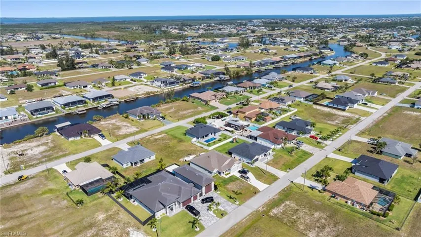 Birds eye view of property featuring a water view and a residential view