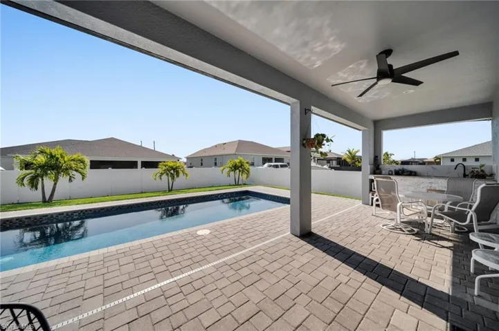 View of swimming pool with a fenced backyard, ceiling fan, a fenced in pool, and a patio