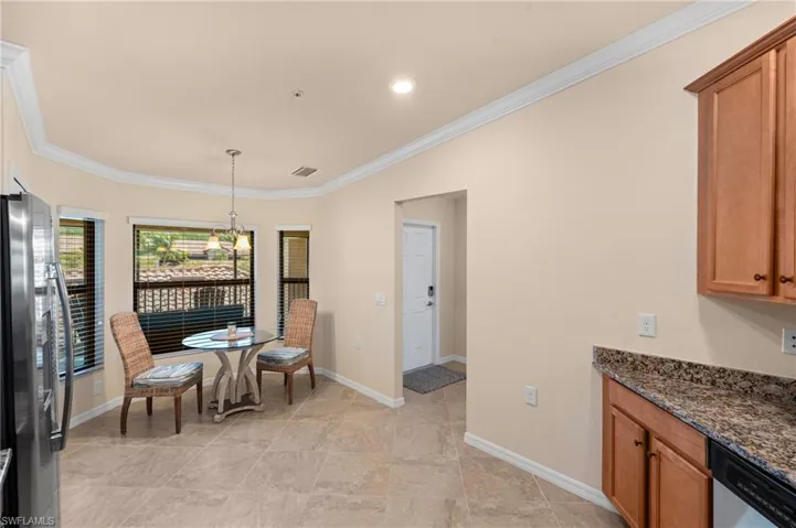 Dining area with baseboards, visible vents, and ornamental molding