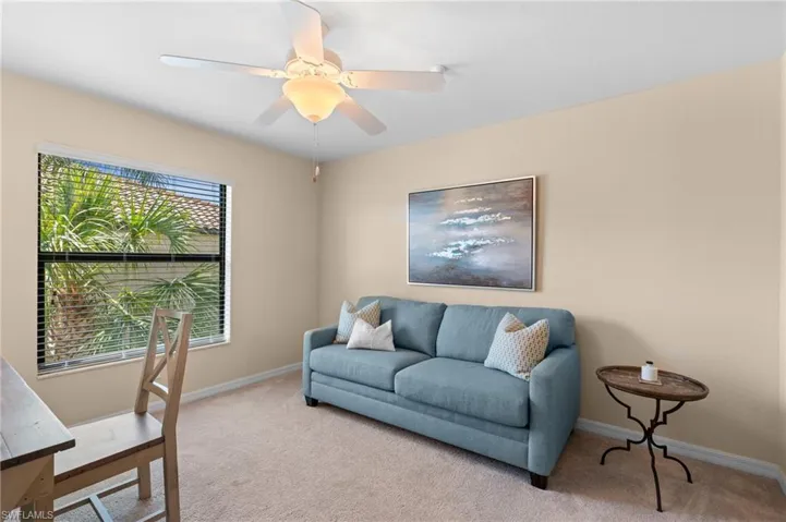 Carpeted office featuring baseboards and ceiling fan