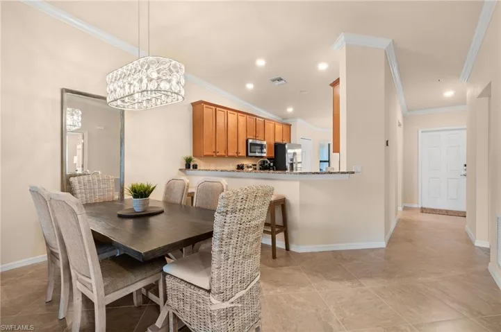 Dining space featuring visible vents, crown molding, lofted ceiling, and recessed lighting