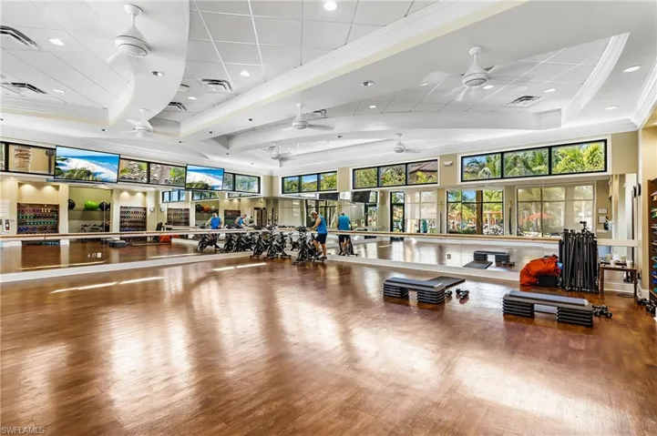 Gym featuring ceiling fan, visible vents, and ornamental molding