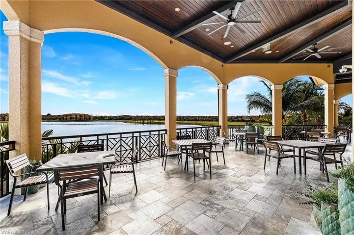 View of patio featuring outdoor dining space, a water view, and ceiling fan