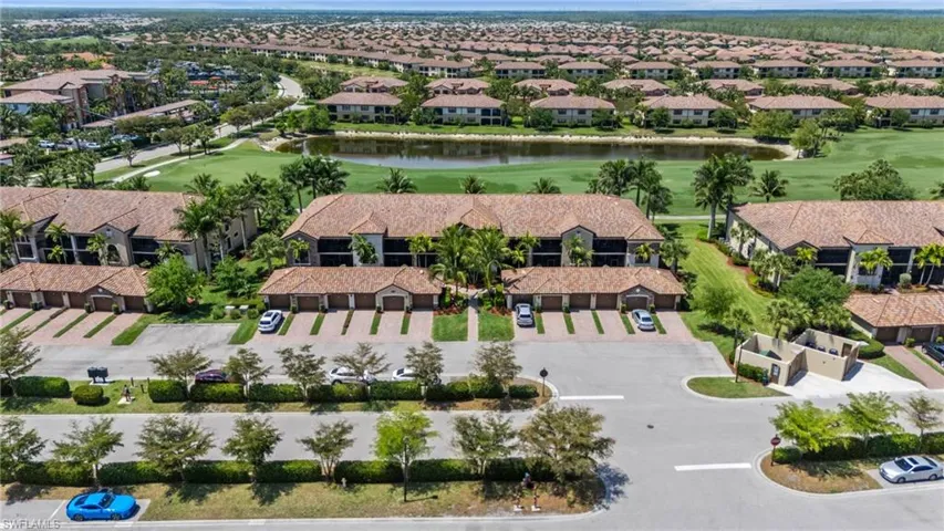 Aerial view featuring view of golf course, a residential view, and a water view