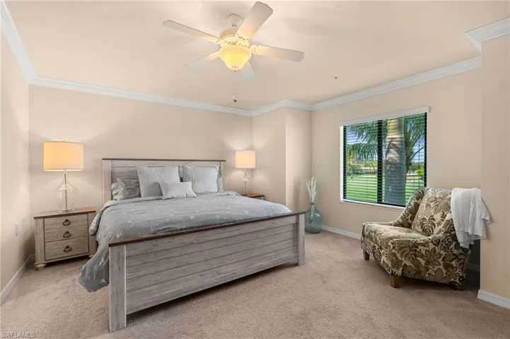 Bedroom featuring light colored carpet, crown molding, and baseboards