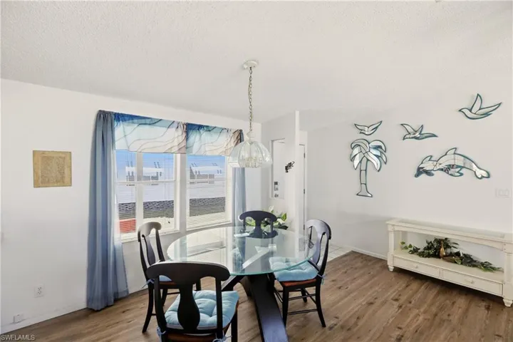 Dining space featuring a textured ceiling and wood finished floors