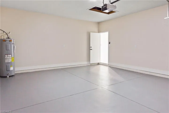 Garage with electric water heater and a garage door opener
