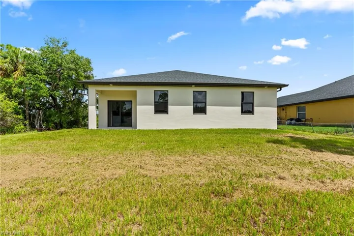Rear view of property featuring stucco siding