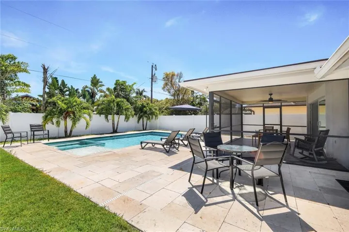 View of pool featuring a patio area and ceiling fan